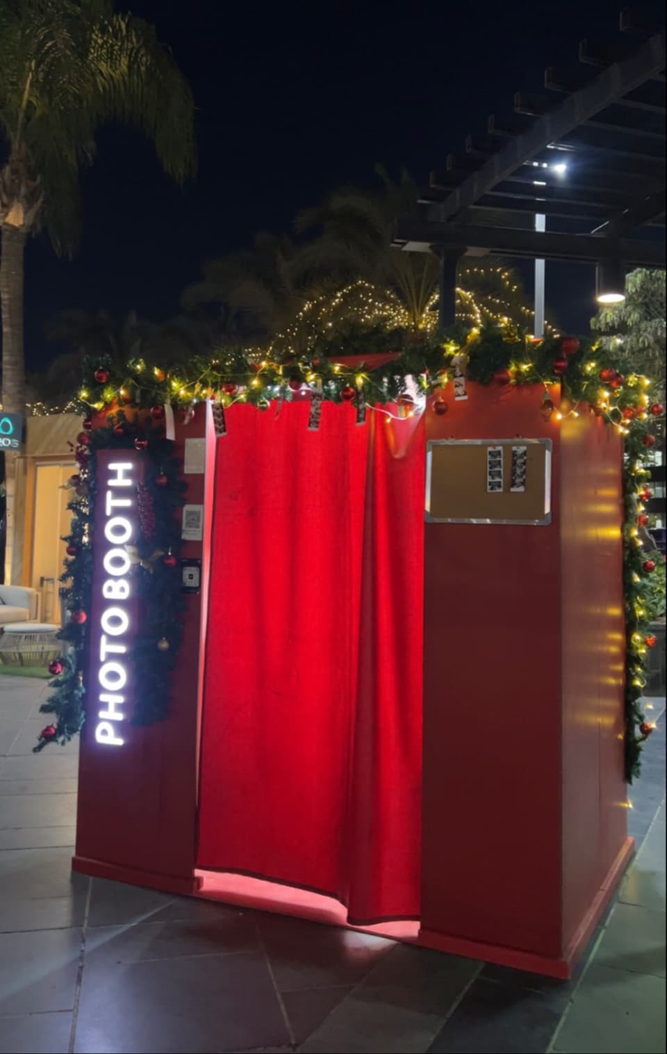 The red photo booth dressed in holiday garlands at Downtown Katameya